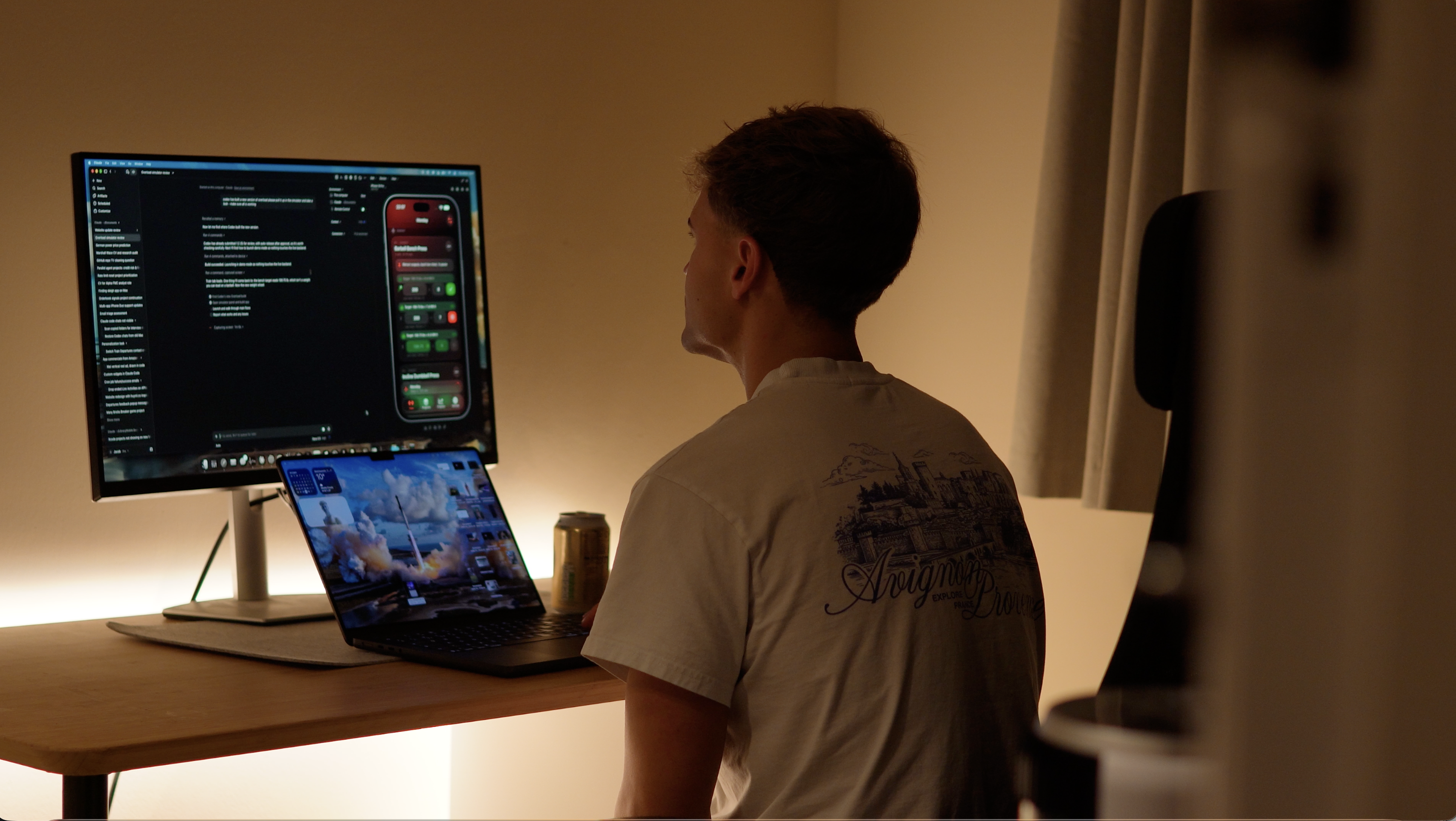 Jacob at his desk, working on his computer in a warmly lit room